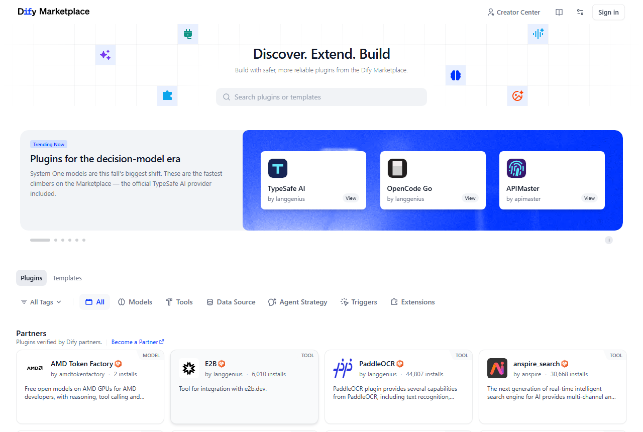 Dify Marketplace home page with the headline Discover. Extend. Build., a plugin search box, a trending banner, category tabs for Models, Tools, Data Source, Agent Strategy, Triggers and Extensions, and partner plugins such as AMD Token Factory, E2B, PaddleOCR and anspire_search with install counts