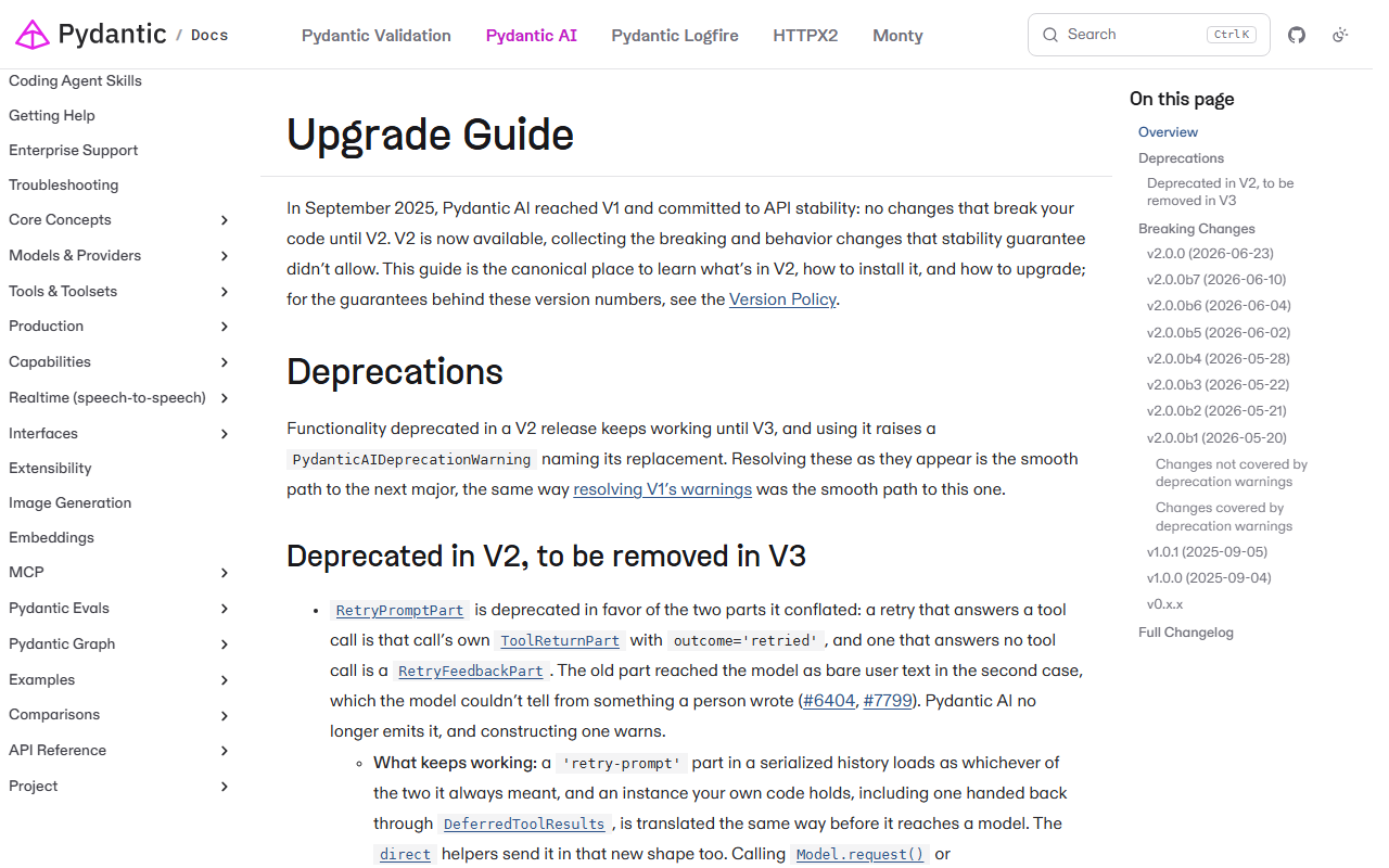 Upgrade Guide page of the Pydantic AI docs saying that in September 2025 Pydantic AI reached V1 and committed to API stability and that V2 is now available, with a table of contents listing v2.0.0 on 2026-06-23 and betas v2.0.0b1 to b7, and a Deprecations section starting with RetryPromptPart
