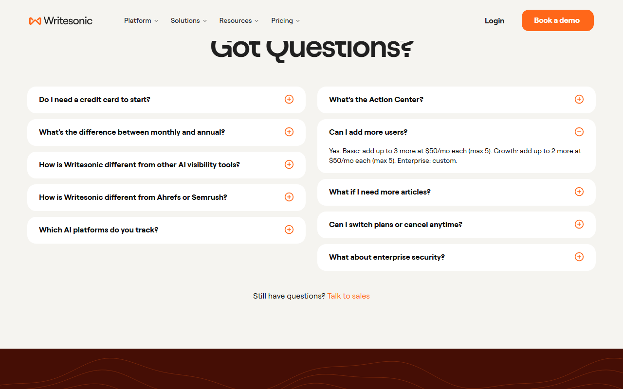 Writesonic pricing FAQ with the question Can I add more users expanded, answering Yes, Basic: add up to 3 more at 50 dollars a month each (max 5), Growth: add up to 2 more at 50 dollars a month each (max 5), Enterprise: custom